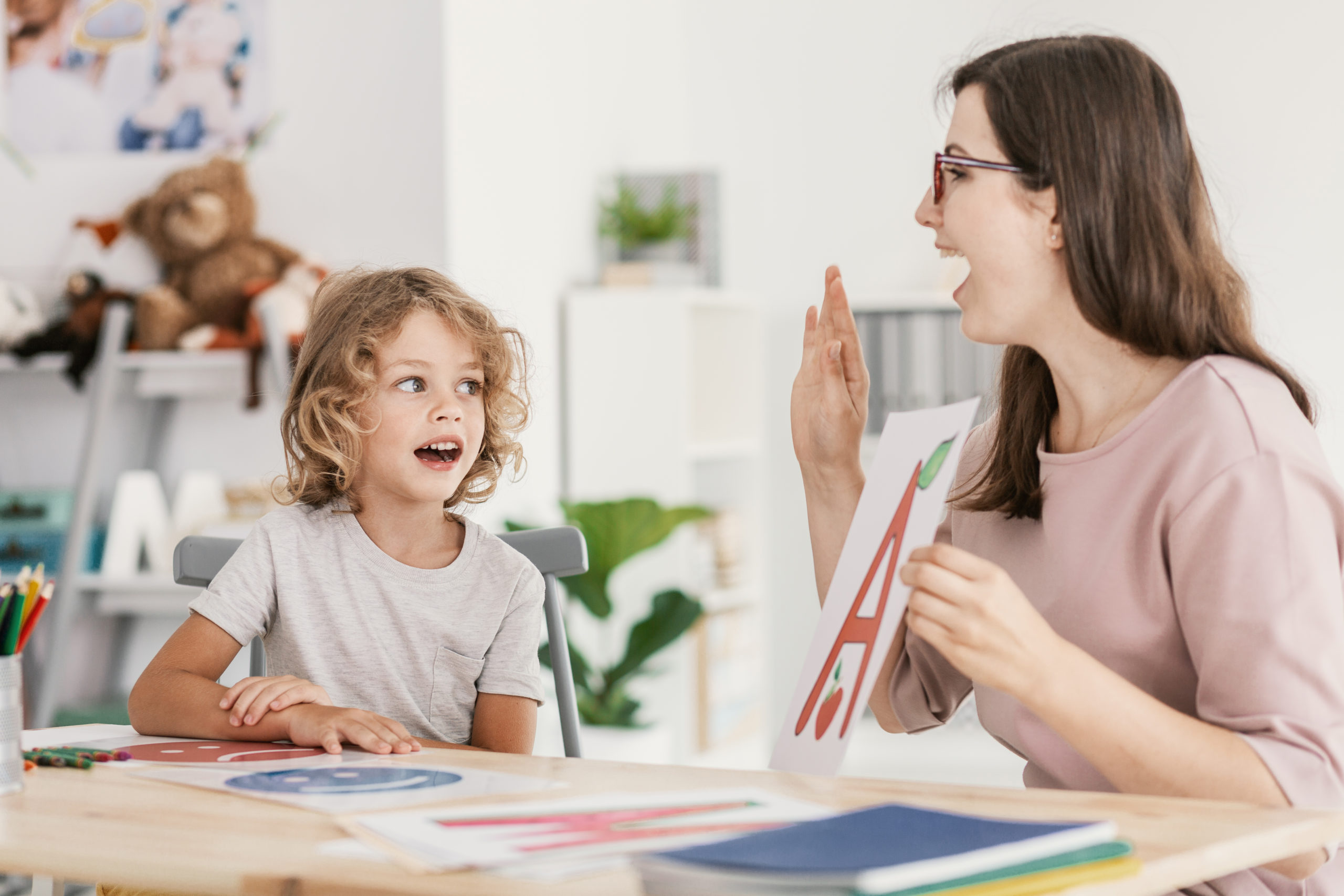 Tutor and student learning alphabet