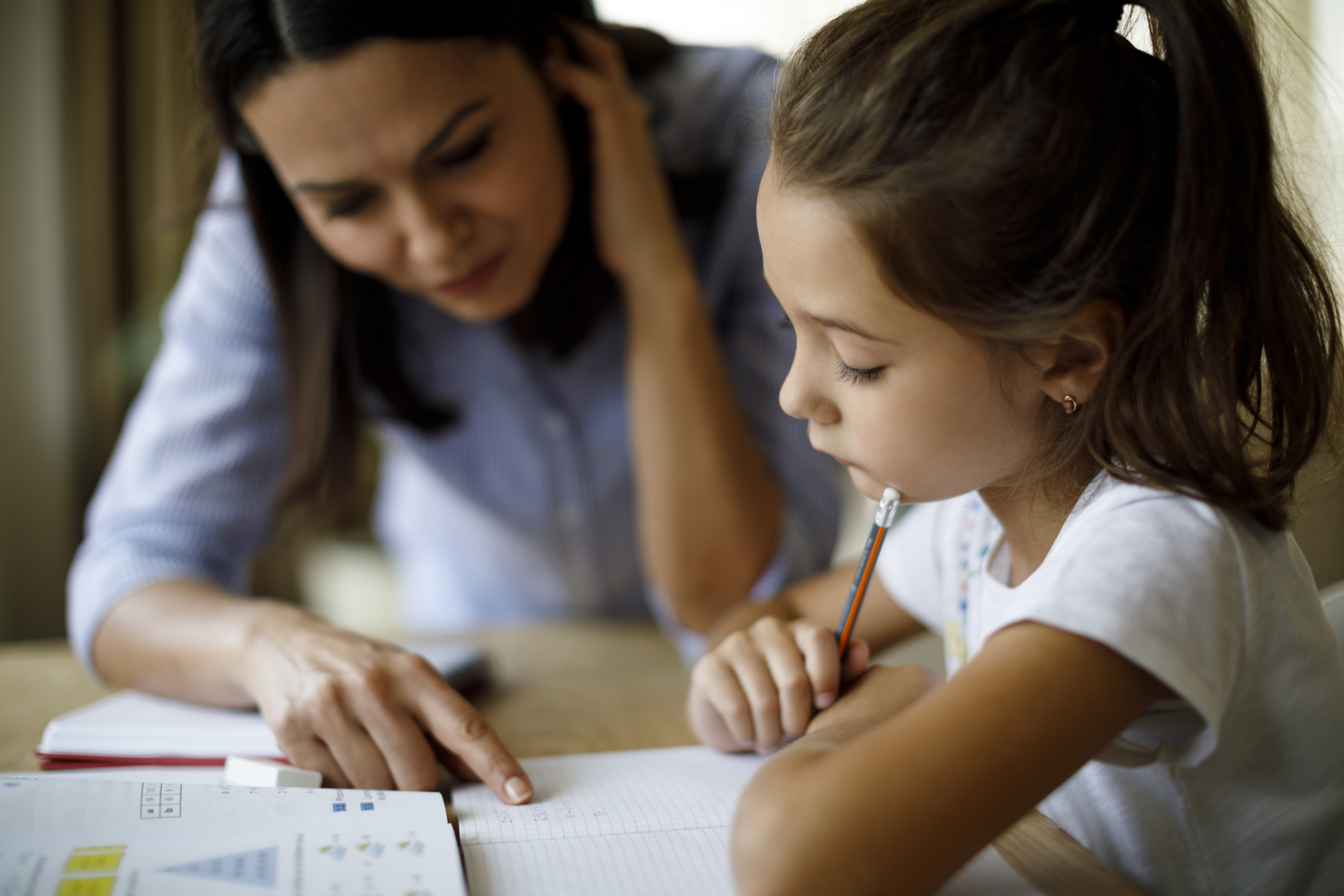 Tutor helps student in home tutoring Teacher helps student in home tutoring