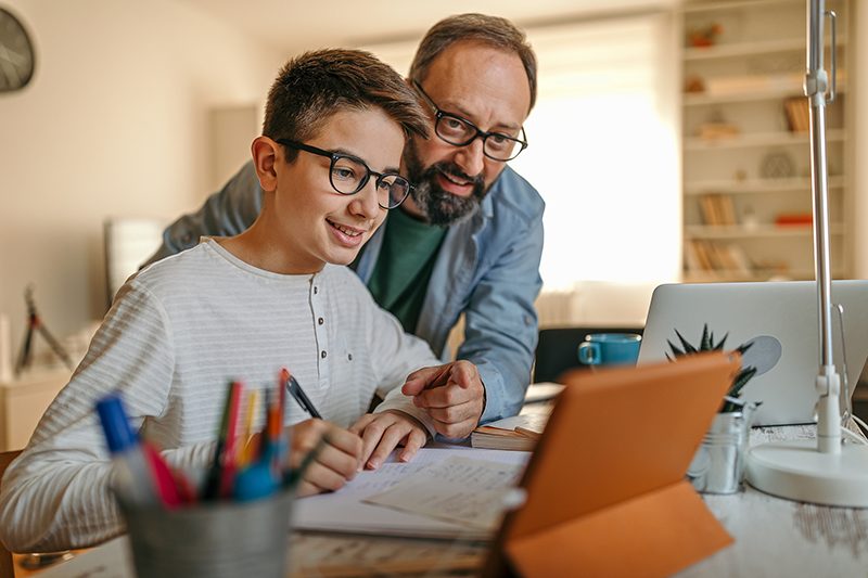 Parent helping student with online class